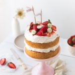 A simple strawberry cream cake made of layers of vanilla sponge cake, soft whipped cream, and fresh strawberries | prettysimplesweet.com