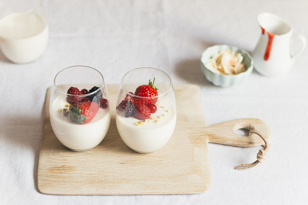 Perfect Panna Cotta mini desserts in glasses topped with fresh berries.