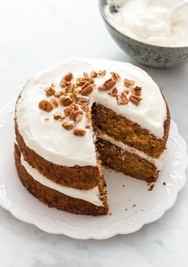 The ultimate layered carrot cake - incredibly moist, fluffy, and flavorful, and topped with the most amazing cream cheese frosting. | prettysimplesweet.com