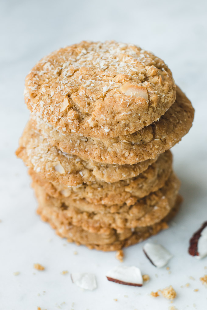 Large stack of toasted Coconut Cookies with large toasted coconut flakes.