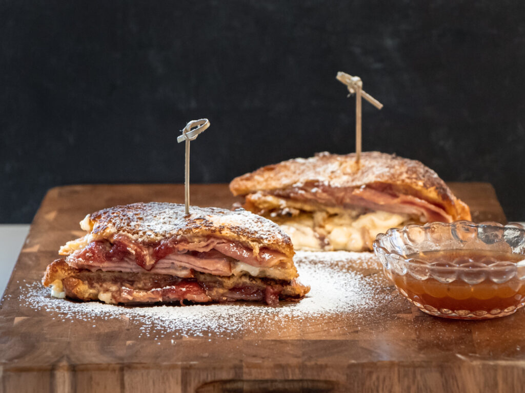 Monte Cristo sandwiches  dusted with powdered sugar, served with maple dipping sauce on the side