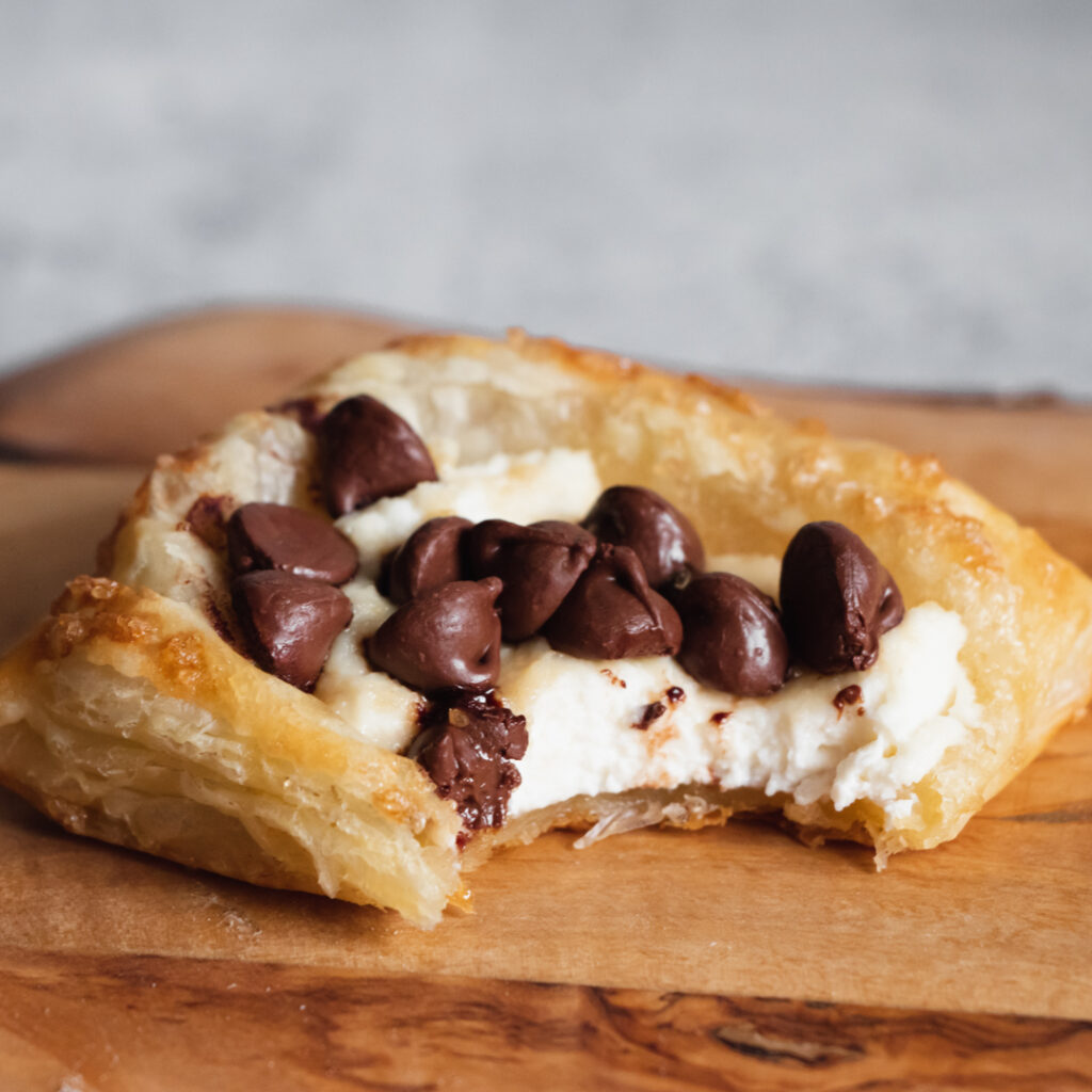 Ricotta chocolate chip puff pastry square with bite taken