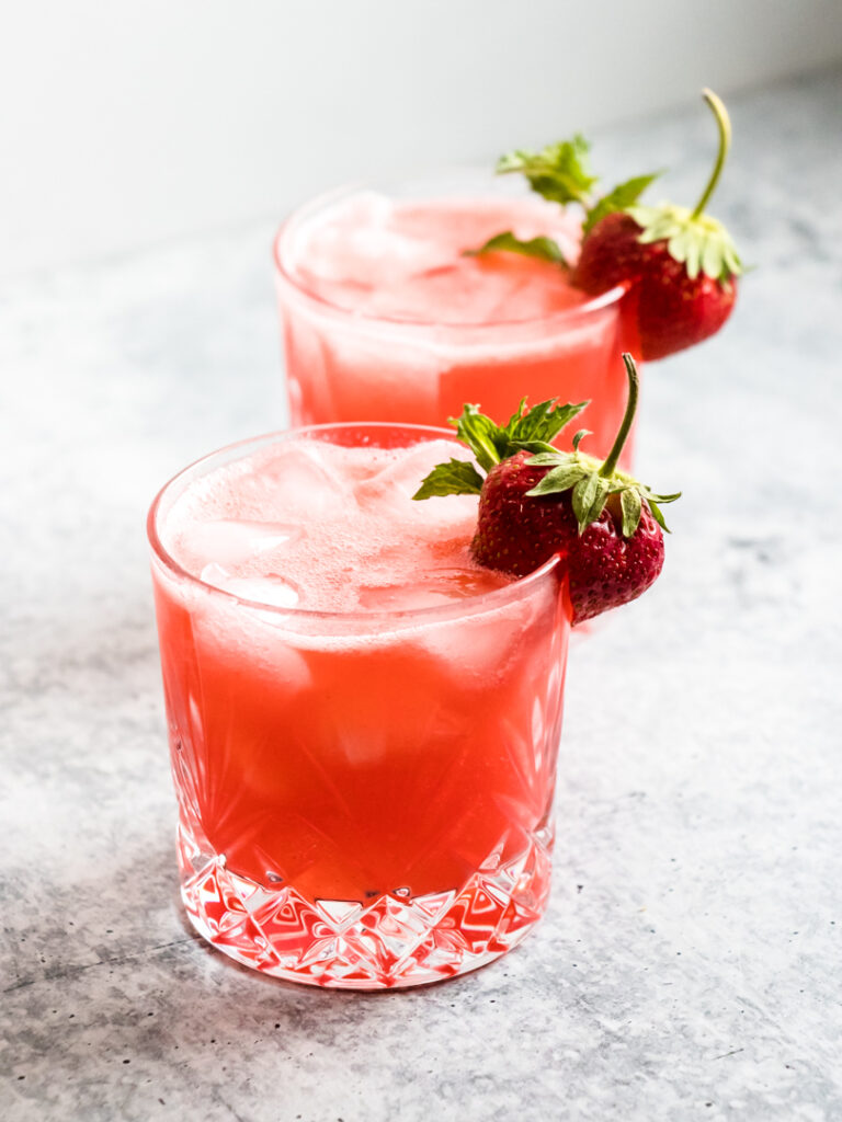 Strawberry Gin Hoppy Refresher Cocktails garnished with fresh strawberry and mint
