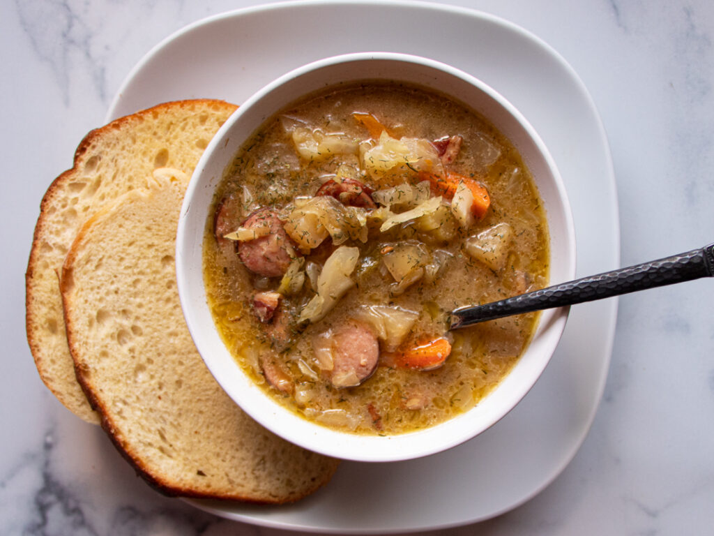 bowl of sauerkraut soup with toasted bread