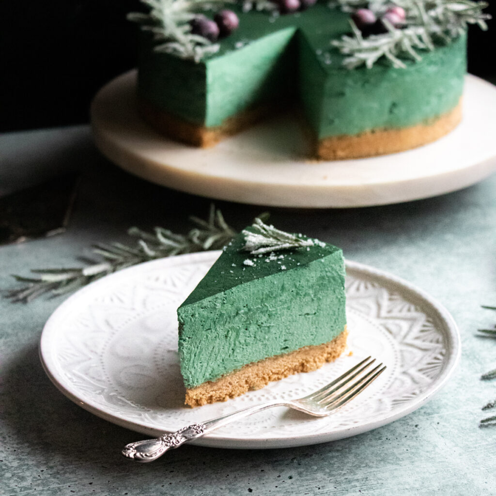 slice of green spirulina cheesecake (dye-free, no-bake)