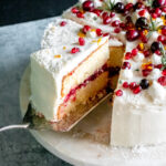 orange layer cake with cranberry filling and cream cheese frosting