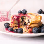 Triple blueberry pancakes have blueberries added twice to the batter and once to the fresh homemade blueberry syrup on top.