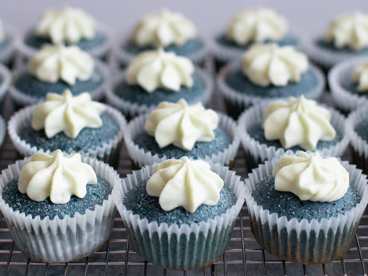 Spirulina cream cupcakes with fluffy cream cheese frosting and sanding sugar.