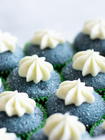 Gorgeous blue spirulina cream cupcakes with cream cheese frosting and sanding sugar.