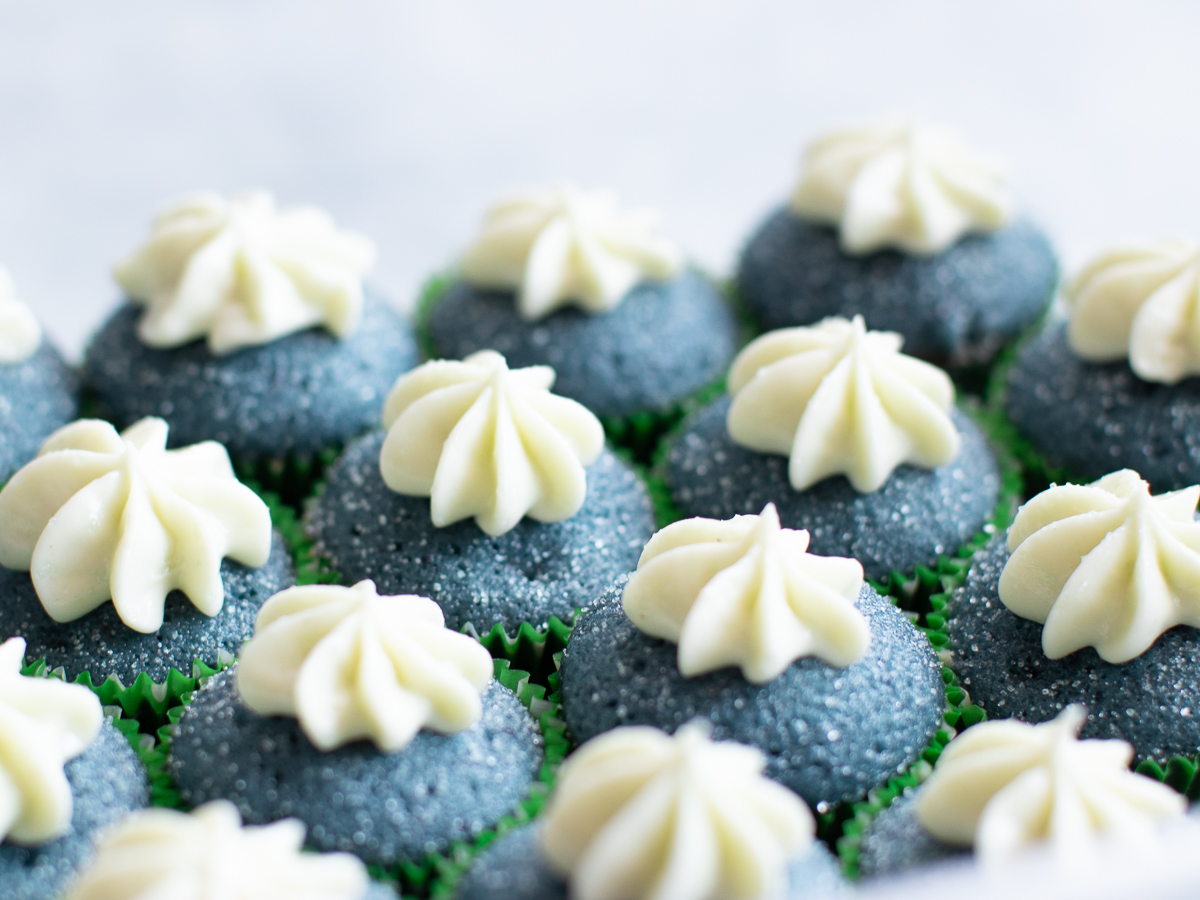 Gorgeous blue spirulina cream cupcakes with cream cheese frosting and sanding sugar.