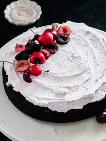 Cherry garcia cake is made with chocolate chips, fresh cherries, and a creamy frosting.