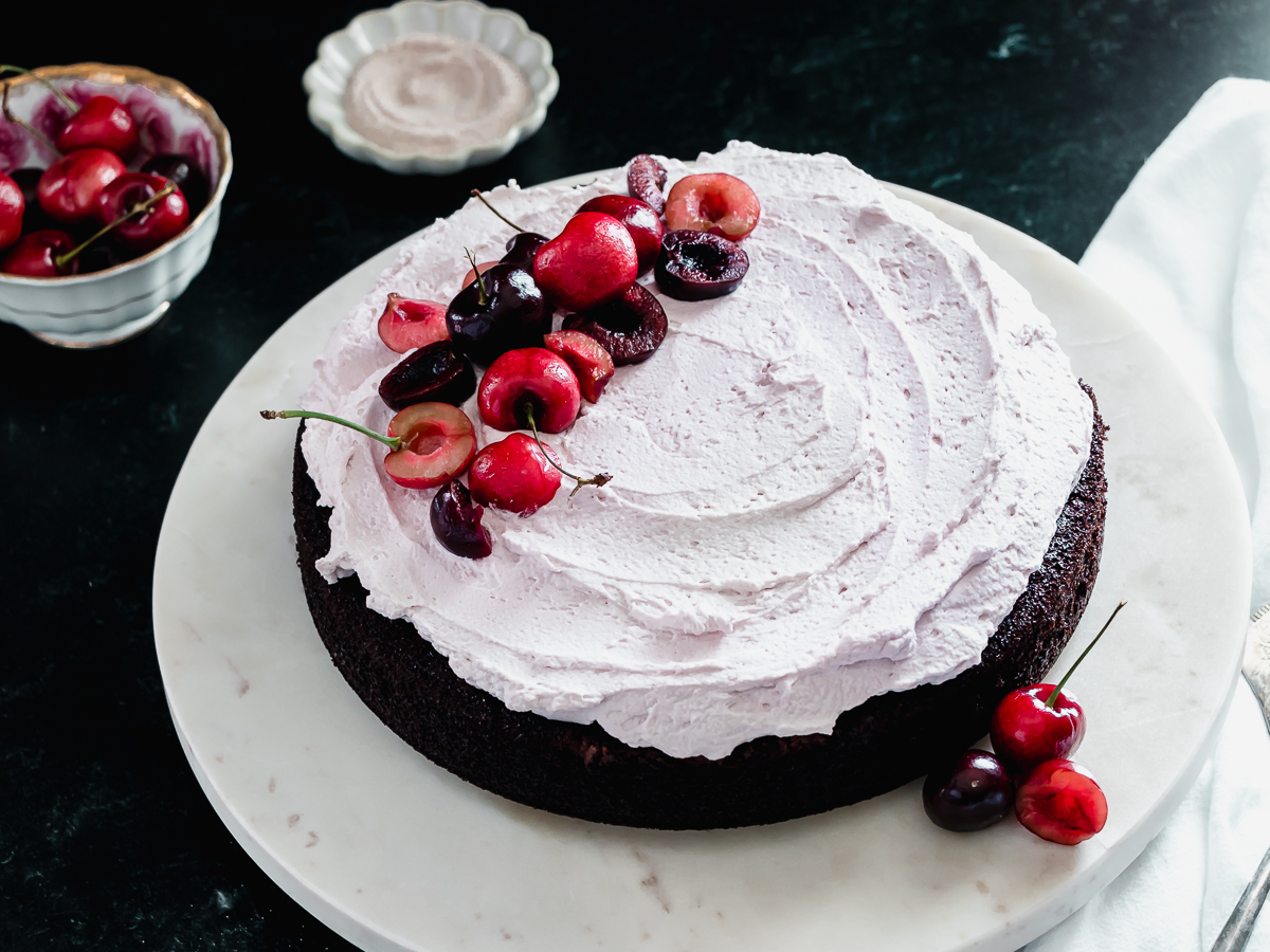 Cherry garcia cake is made with chocolate chips, fresh cherries, and a creamy frosting.