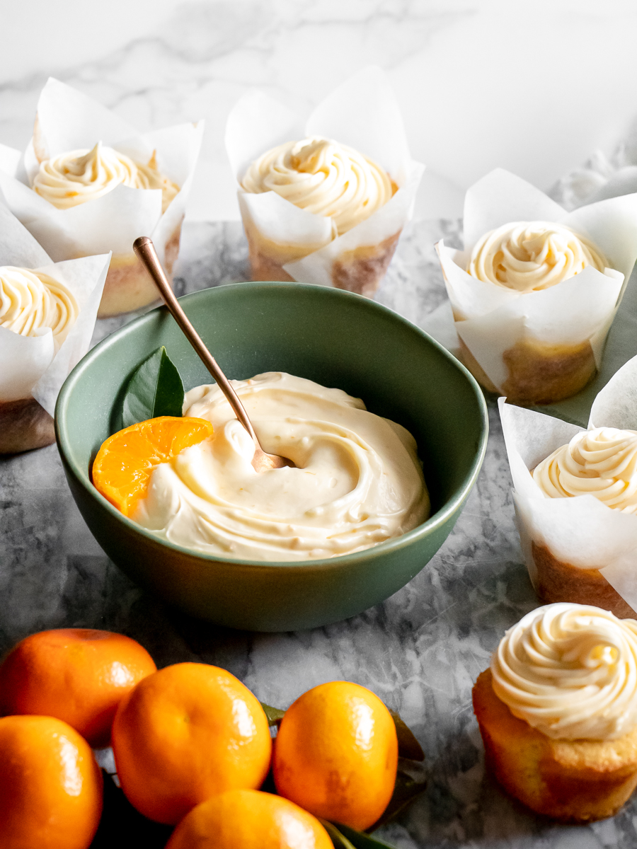 Orange cream cheese frosting is flavored with fresh orange juice and zest.