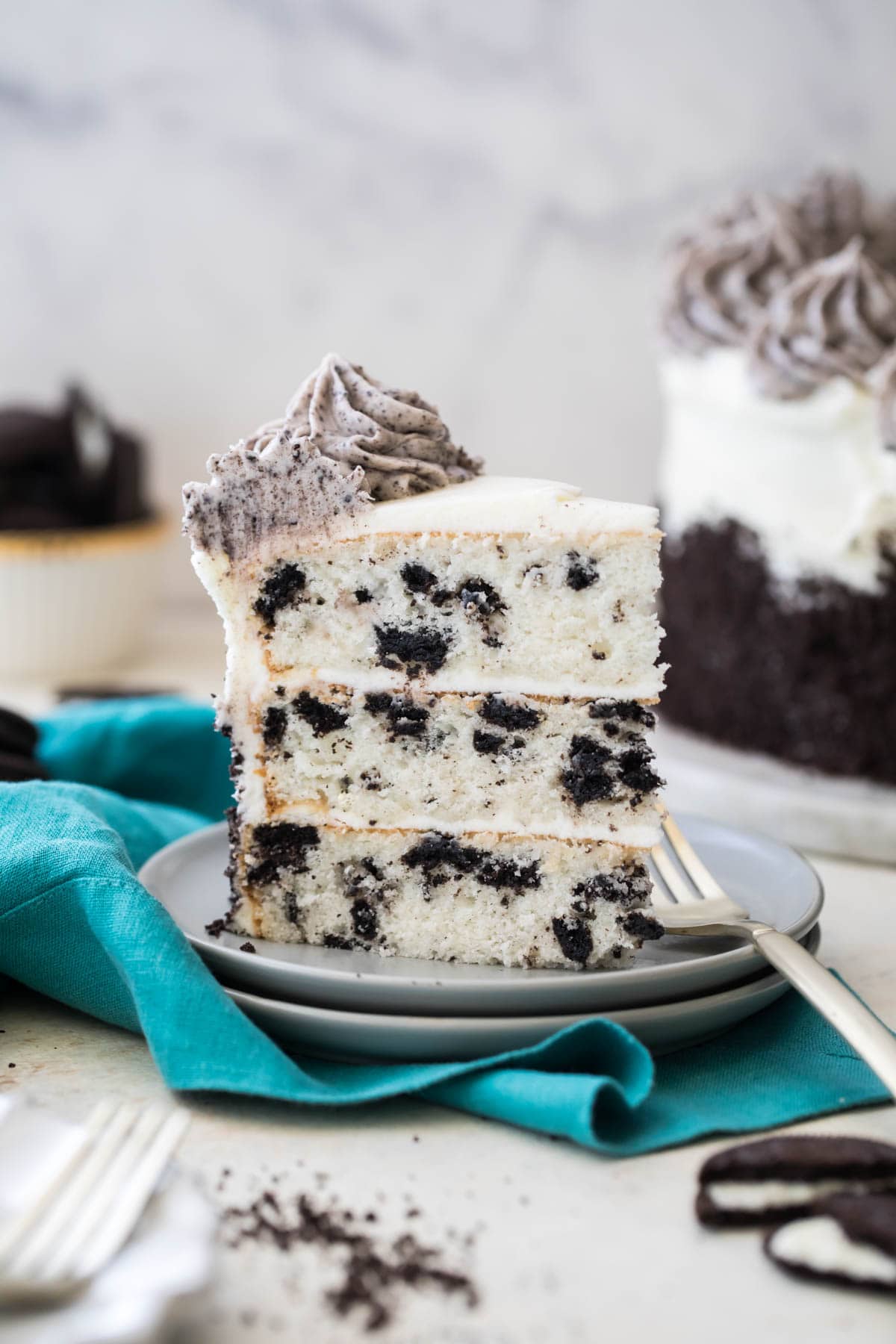 Slice of oreo cookies and cream three-layer cake from Sugar Spun Run.