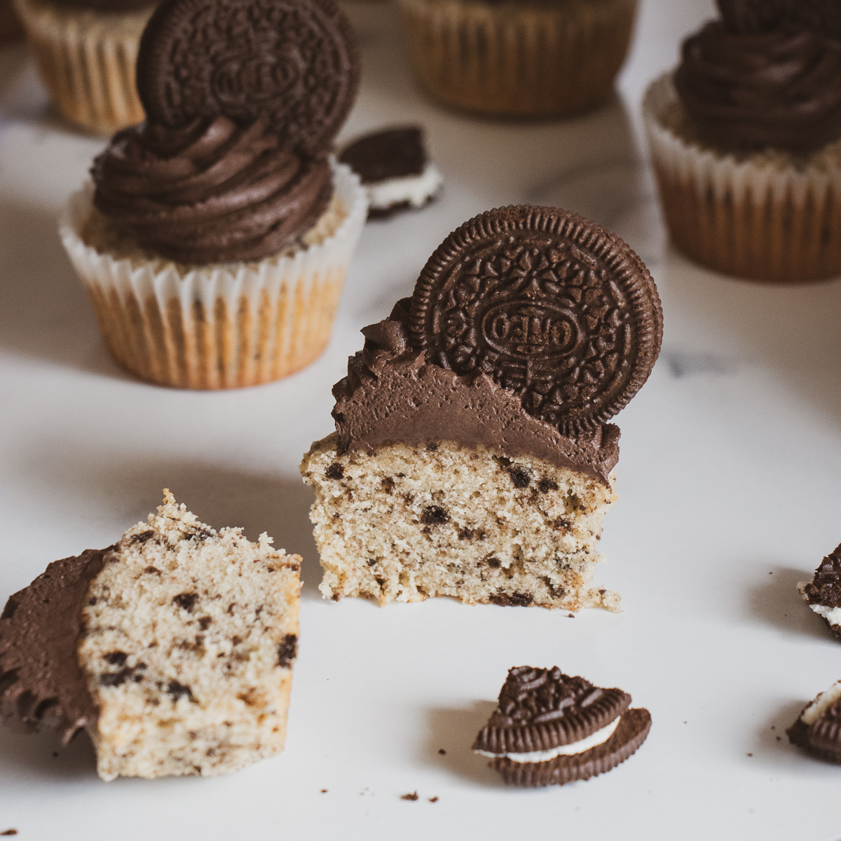 Cookies and cream cupcakes split in half to reveal the cookie crumb centers.