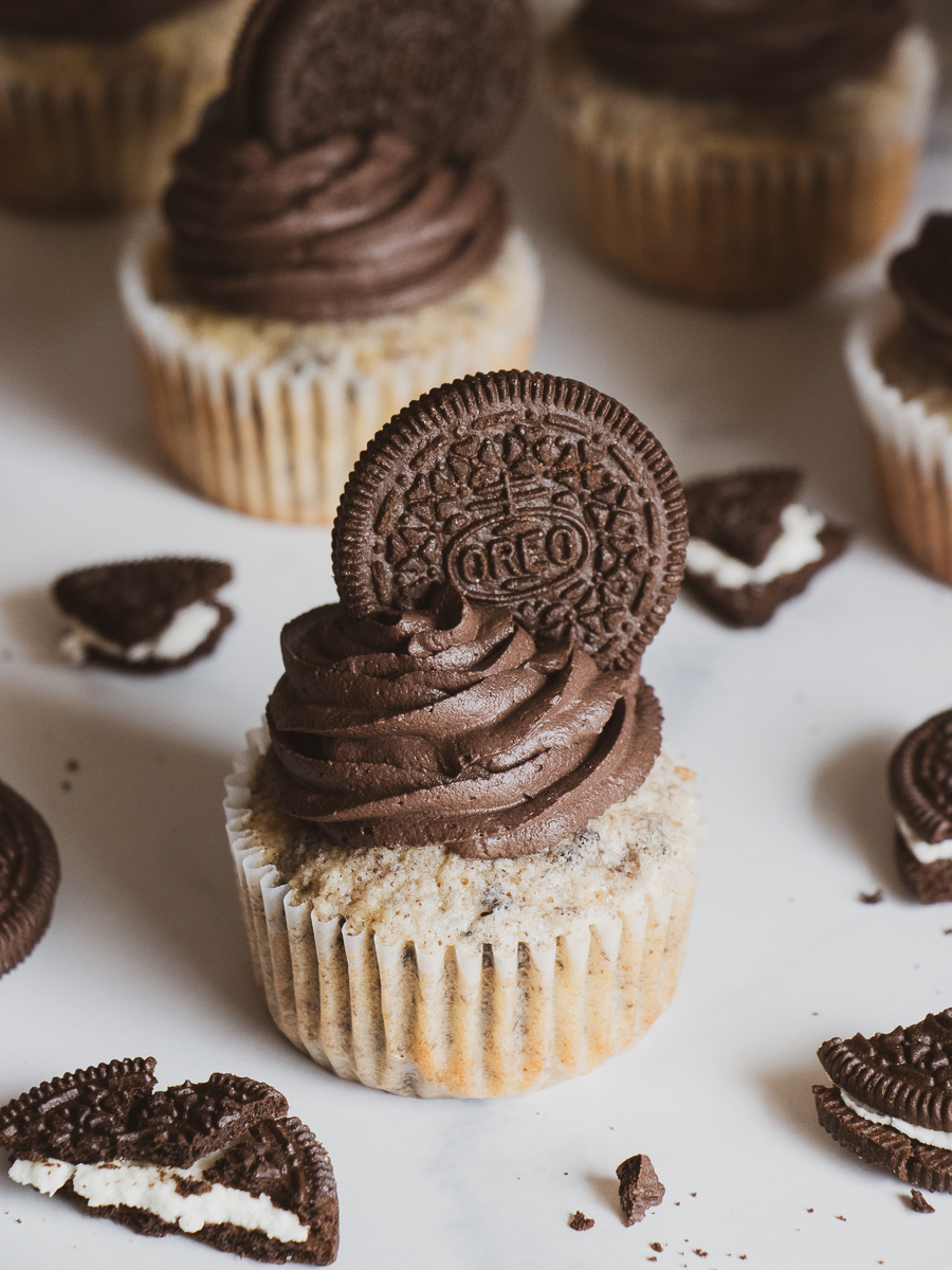 Cookies and cream cake batter cupcakes topped with creamy black cocoa frosting.
